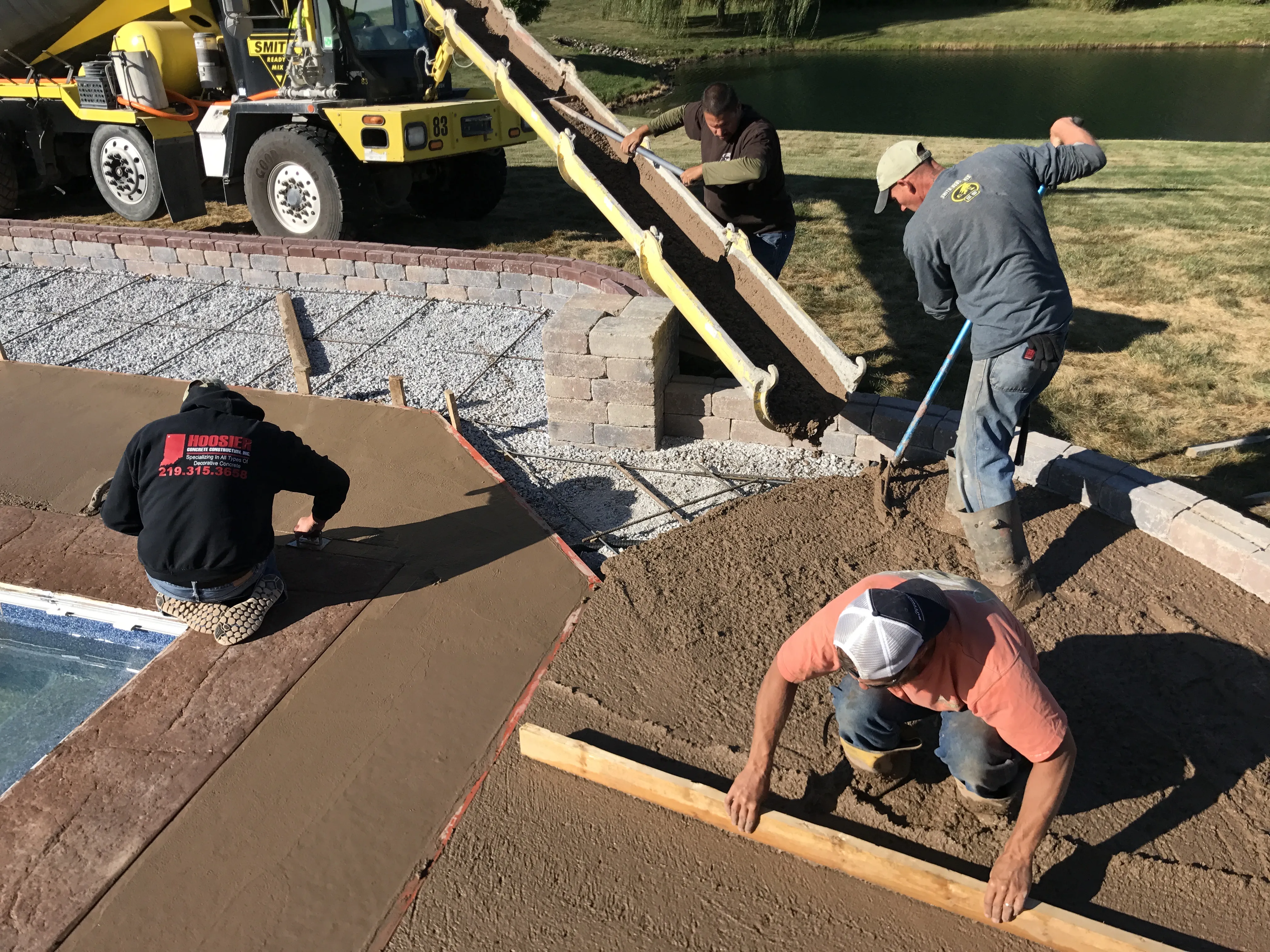 Hoosier Concrete Final Hoosier Concrete Construction crew pouring and finishing a concrete pool deck in Northwest Indiana